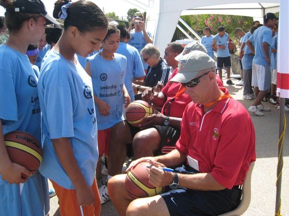 Coach Rick Walrond signing basketballs for players at the Uariachi Hoop Camp in Rabat, Morocco